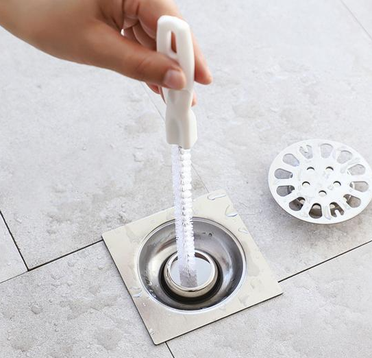  Cleaning a floor drain where drain flies breed